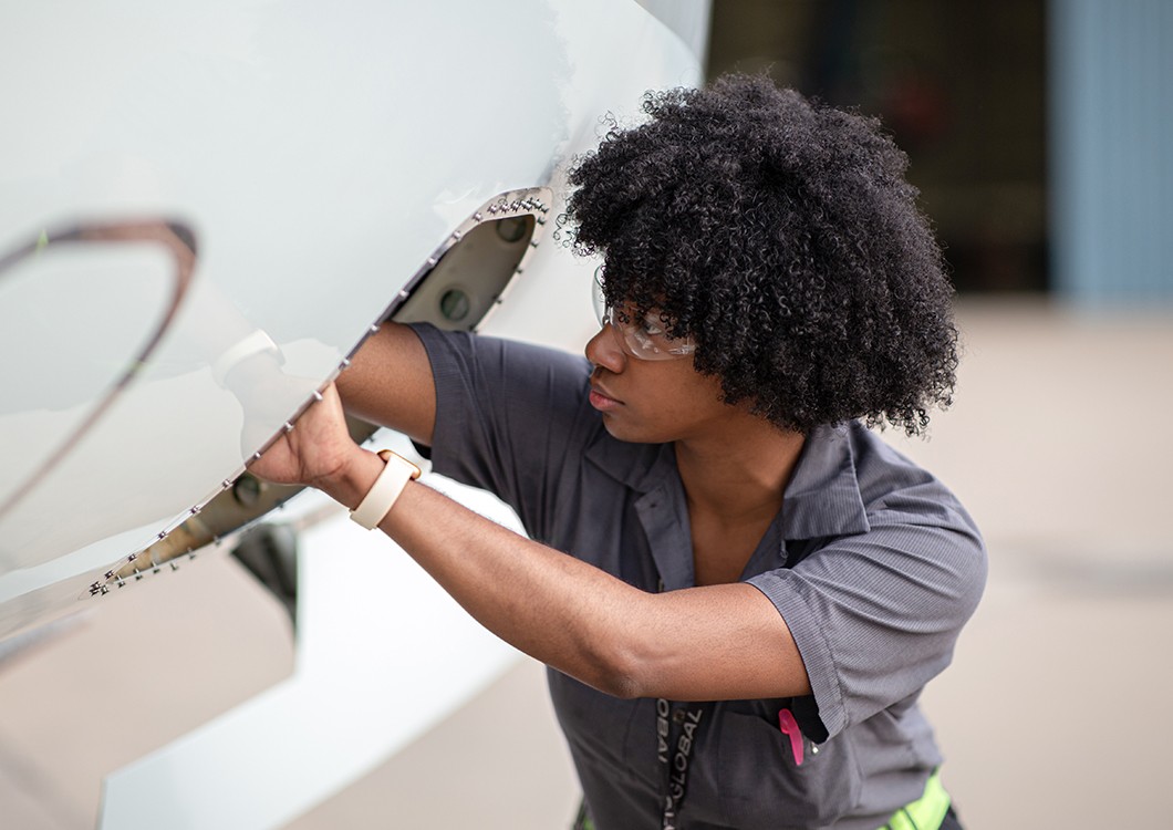 female employee working on the exterior of an aircraft