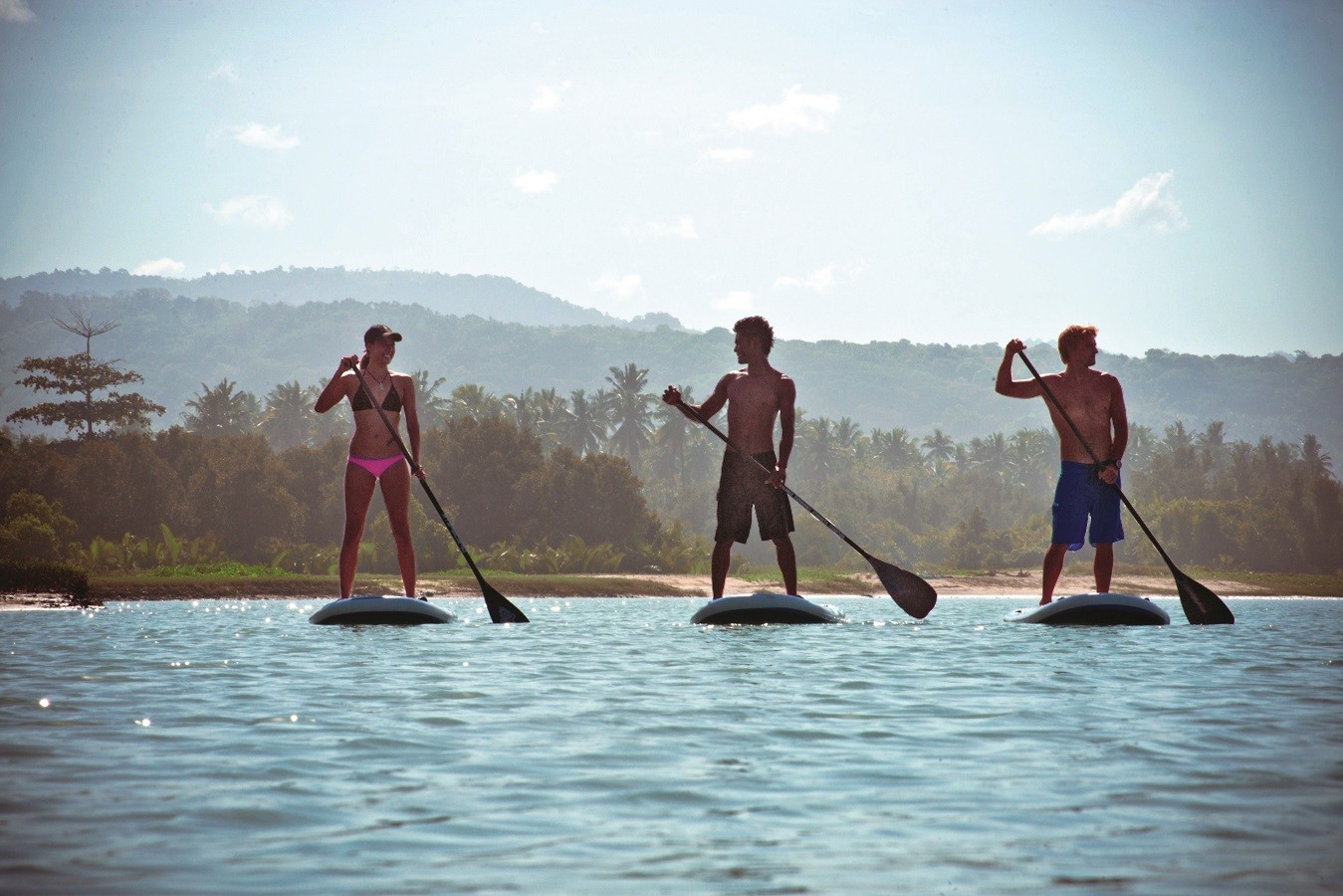Young boys paddleboard at Nihiwatu