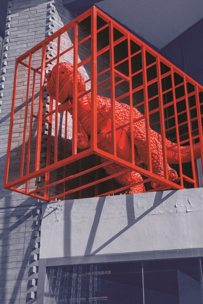 A sculpture of a red dinosaur in a cage made by artist Sui Jianguo on display in Beijing’s 798 Art District.