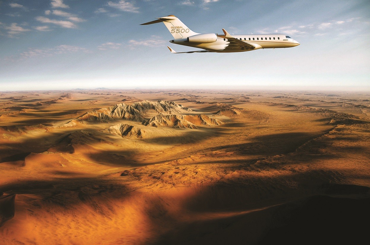A Global 5500 jet flies over the desert